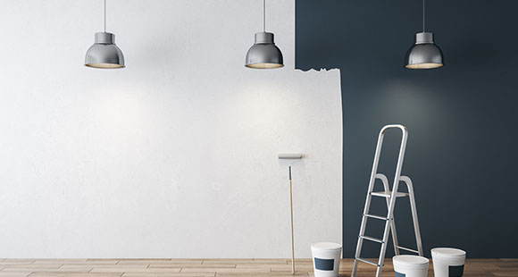 a view of a wall that is in the process of being painted from black to white